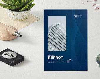 May include: A blue and white annual report cover with a modern design. The cover features a photo of a building with a curved roof and the text "ANNUAL REPROT".