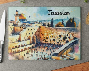 May include: Rectangular glass cutting board featuring a watercolor illustration of Jerusalem. The image depicts the city's architecture, including the Dome of the Rock and the Western Wall, with the word "Jerusalem" in black script.