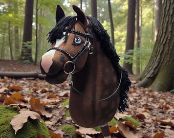 May include: A brown hobby horse with a black mane and a detailed bridle. The horse has a white patch on its face and is set against a forest backdrop. The stick is made of wood.