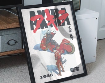 May include: A framed poster with a red and black illustration of a motorcycle and a person in a red jumpsuit. The poster has the text "AKIRA" in large red letters and "1988" in black letters at the bottom.