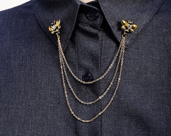 May include: A gold chain necklace with two butterfly-shaped charms. The necklace is layered with three chains of different thicknesses.