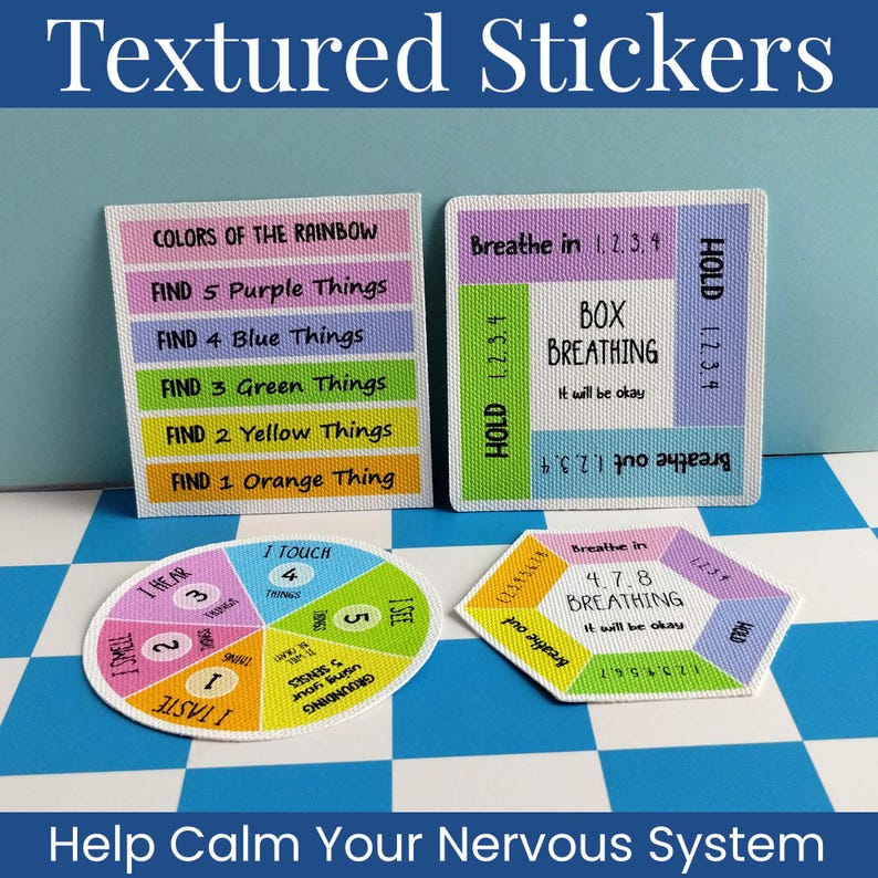 May include: Four textured stickers with grounding and breathing exercises. Two are square, one is circular, and one is hexagonal. They feature colorful sections with text including "Colors of the Rainbow," "Box Breathing," "4-7-8 Breathing," and "5 Senses."