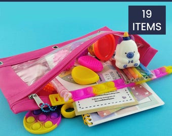 May include: A pink pencil case filled with sensory items. The case contains a variety of items, including a pop-it bracelet, a small notebook, a unicorn figurine, and a container of playdough. Text on the image reads "Sensory & Emotions Calm Kit" and "19 Items."