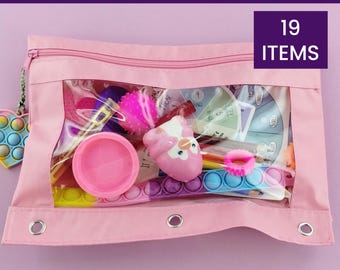 May include: A pink zippered pouch with a clear window, filled with various sensory items. The pouch contains a variety of colorful fidget toys, a pink owl-shaped squeeze toy, and other items. Text on the image reads "SENSORY & EMOTIONS CALM KIT" and "19 ITEMS".