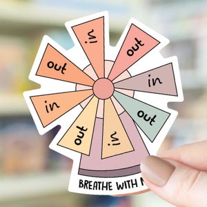 May include: A colorful sticker with a windmill design and the words "in" and "out" repeated around the circle. The text at the bottom reads "BREATHE WITH ME".