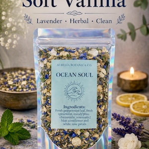 May include: A clear, holographic pouch filled with a dried herbal blend. The label reads Aurelia Botanica Co. Ocean Soul, listing ingredients: fresh peppermint leaf, fresh spearmint, eucalyptus, chamomile, rosemary, blue cornflower, and white rose petals.