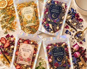 May include: Four iridescent pouches of botanical simmer pot blends labeled Garden of the Sun, Indigo Serenity, Self Love Ritual, and Midnight Sanctuary. Each pouch contains dried flowers, fruit slices, and spices, surrounded by loose ingredients.