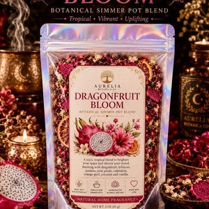 May include: A holographic pouch of Aurelia Botanica Co. Dragonfruit Bloom botanical simmer pot blend. The label features a dragonfruit and hibiscus illustration with text describing the 3 oz (85 g) natural home fragrance blend.