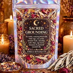 May include: A holographic pouch filled with a botanical blend of white sage, rose petals, lavender buds, calendula, cedar chips, and cinnamon. The label reads SACRED GROUNDING, An earthy, centering blend with white sage, rose petals, lavender buds, calendula, ceder chips, sage leaves, cinnamon & patchouli essential oils, AURELIA BOTANICA CO.