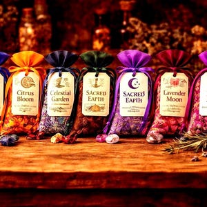 May include: A collection of six colorful sachets with labels, each tied with a ribbon. The labels read "Ocean Soul", "Citrus Bloom", "Celestial Garden", "Sacred Earth", "Sacred Earth", "Lavender Moon", and "Rose Aura".