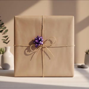 May include: A square gift box wrapped in plain light brown paper, tied with thin natural twine that forms a bow at the center. A small, shiny, metallic purple decorative bow is attached to the twine, positioned slightly above the center knot.