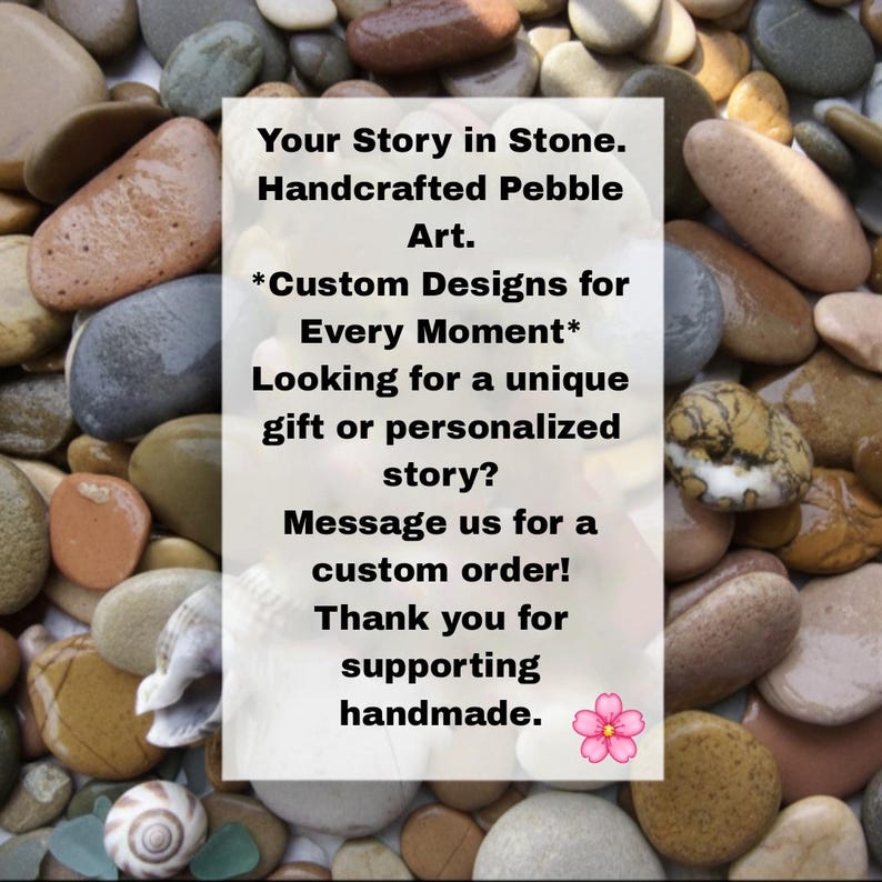 May include: A collection of smooth, multi-colored river pebbles surrounding a central white rectangular sign with black text that reads: Your Story in Stone. Handcrafted Pebble Art. *Custom Designs for Every Moment* Looking for a unique gift or personalized story? Message us for a custom order! Thank you for supporting handmade. A small pink flower icon is at the bottom right.