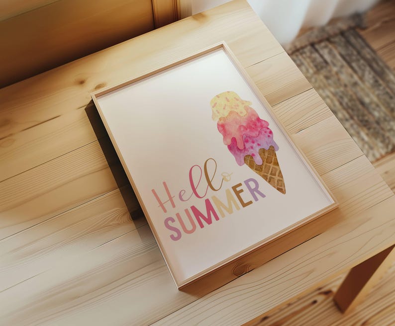 May include: A framed print with a watercolor illustration of a melting ice cream cone in pink, yellow, and purple colors. The text "Hello Summer" is written in a pink, yellow, and purple font.