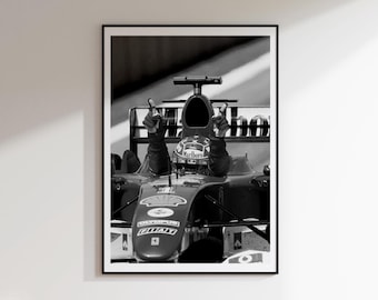 May include: Black and white framed print of a Formula 1 race car with a driver wearing a helmet. The driver is raising both hands in a victory gesture. The car has sponsor logos, including "Marlboro" and "Shell".