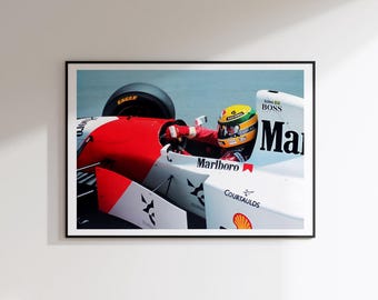 May include: A framed wall art print featuring a Formula One race car in red and white livery with Marlboro, Boss, and Courtaulds branding. A driver wearing a yellow, green, and blue helmet is inside the cockpit of the vehicle on a track.