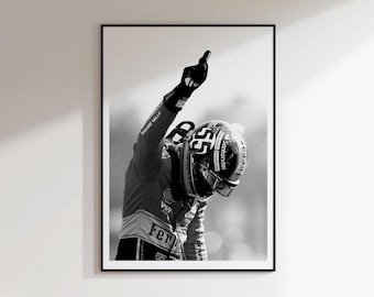 May include: A black and white framed wall art print featuring a race car driver wearing a helmet with the number 55 and Santander branding. The driver is shown from the chest up, raising one gloved hand with a finger pointed upward.