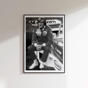 May include: Black and white framed print featuring a Formula 1 driver sitting on a race car. The driver is wearing a racing suit with sponsor logos. The car has the "Marlboro" logo and "Texaco" branding.