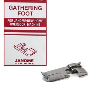 May include: A silver gathering foot for a Janome/New Home overlock machine. The product is displayed next to its red and white packaging, which includes the text "GATHERING FOOT" and "FOR JANOME/NEW HOME OVERLOCK MACHINE."
