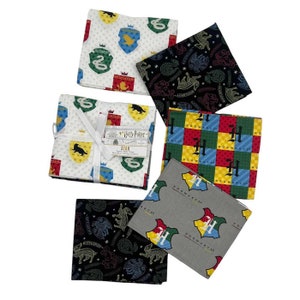 May include: A set of 10 fabric squares featuring Harry Potter house crests and Hogwarts logos. The squares are in various colours, including red, yellow, blue, green, and black. The fabric is printed with a variety of designs, including the Hogwarts crest, the house crests, and the words "Hogwarts" and "Harry Potter".