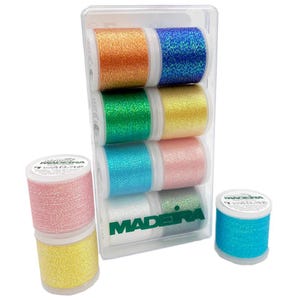 May include: A selection of Madeira glitter thread spools in a clear plastic case. The spools are in various colours, including orange, blue, green, yellow, pink, and teal. Additional spools are stacked separately. The thread has a sparkly, glittery appearance.