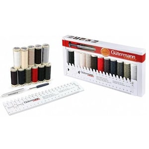 May include: A set of 12 Gutermann thread spools in a variety of colours, including black, white, red, and grey. The spools are arranged in a white plastic case with a ruler and needle threader. The case has the Gutermann logo and the text "Sew All" printed on it.