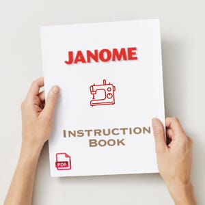 Peut inclure: Un manuel d'instructions blanc tenu par des mains, avec le mot "JANOME" en rouge en haut. En dessous, un dessin au trait rouge d'une machine à coudre et les mots "INSTRUCTION BOOK" en marron. Une petite icône PDF est dans le coin inférieur gauche.