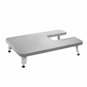 May include: A grey sewing machine extension table with four white legs and black feet. The table has a cut-out for the sewing machine and the Singer logo is printed on the table.
