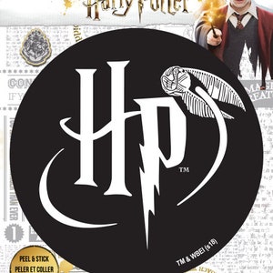 May include: Black and white sticker featuring the Harry Potter logo with a lightning bolt and a golden snitch. The sticker is on a black background and has the text "Harry Potter" and "TM & WBEI (s18)" on it. The sticker is labelled "Peel & Stick" and "Adhesive Fabric".