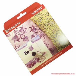 May include: A white box with a red border and the text "Husqvarna" and "VIKING®" printed on it. The box features an image of a sewing machine with fabric and the text "KEEPING THE WORLD SEWING" and "www.sewingmachinesales.co.uk".