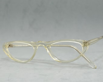May include: Clear plastic cat-eye glasses with a thin frame.