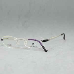 Lunettes de vue vintage sans monture AIGNER. Bêta-titane. Acier inoxydable. SNP non porté ovale étroit unisexe femme homme Top qualité argent noir élégant