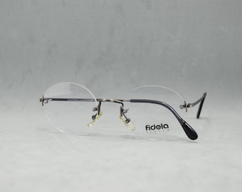 80s 90s Top Vintage Rimless EyeGlasses FIDELA France NOS Unworn Classic round Unisex man Woman Rx eyewear. Big size. Old gunmatel and black.