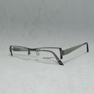 May include: Gray metal frame eyeglasses with clear lenses. The brand name "whynot plus" is printed on the right temple.