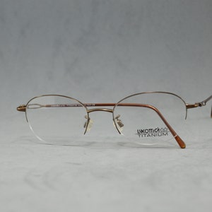 Vintage eyeglasses LUXOTTICA titanium NOS Unworn Classic regular size Oval Half rimless frame Made italy Rx spectacles googles 00s woman