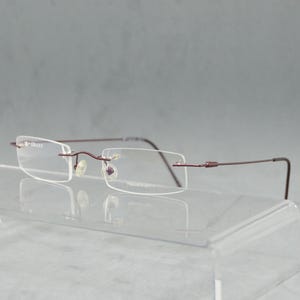 Lunettes de vue sans monture vintage GRANT 1929, Italie. Bêta-titane. NSA. Lunettes de lecture unisexes rectangulaires non portées. Objectifs RX inclus