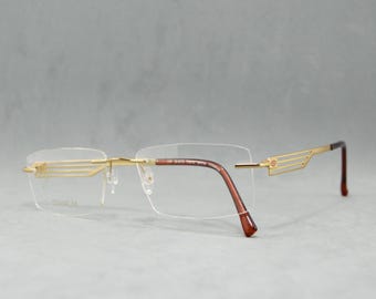 Gafas de sol vintage sin montura de titanio STEPPER EX-50311 FX012. NOS. Sin usar. Unisex. Mujer. Hombre. Años 00 y 2010. Rectangulares. Gafas. Doradas. Carey