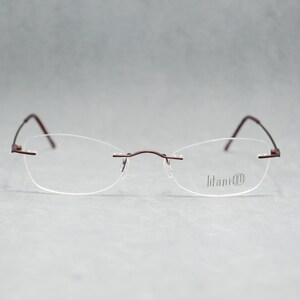 Rimless EyeGlasses TITANIUM 505 07. Dead Stock. Nos Unworn. Unisex Woman. 00s. Garnet. Small cateye. Regular size. 50 18 140 Spec Eyewear image 3
