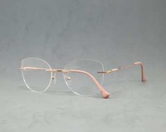 Eyeglasses Eyewear rimless metal Available to Rx. Elegant classic woman. Cateye butterfly shape Regular size. Pale pink cream golden fashion