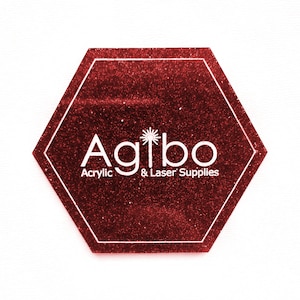 May include: A red hexagonal sign with a white glitter finish. The sign says "Agilbo Acrylic & Laser Supplies" with a starburst design above the text.