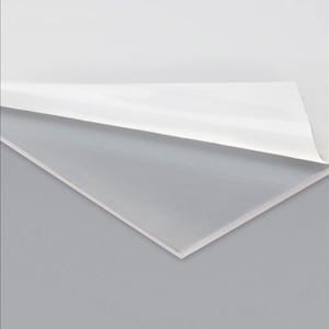 May include: A clear acrylic sheet with a protective paper backing. The backing is partially peeled back to reveal the smooth, transparent surface of the acrylic.