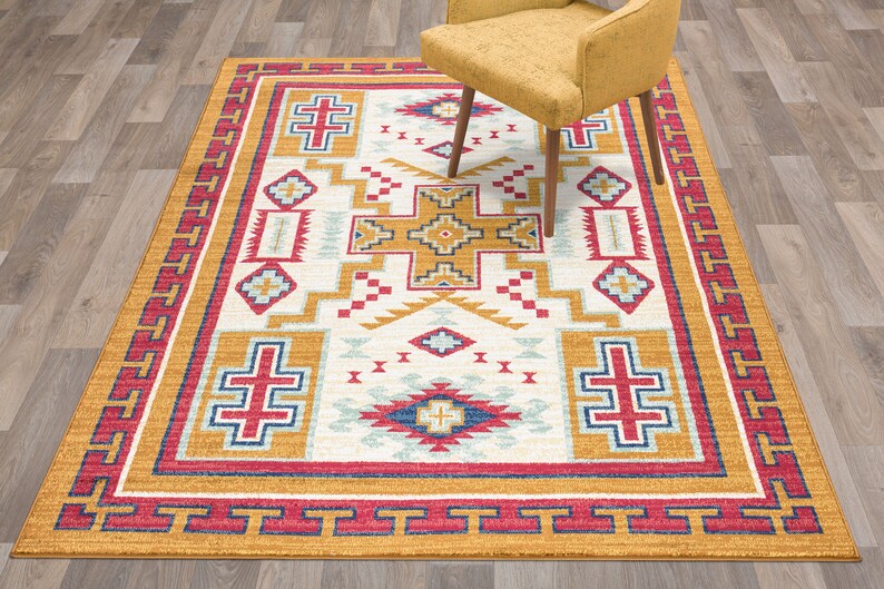 May include: A Southwestern-style area rug with a white background and a geometric pattern in shades of red, yellow, blue, and white. The rug has a border in shades of red, yellow, and blue.