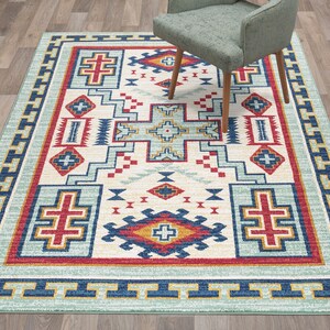 May include: A Southwestern-style rug with a geometric pattern in shades of blue, red, yellow, and white. The rug has a light blue background with a border of yellow and blue.