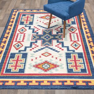 May include: A Southwestern-style rug with a geometric pattern in shades of blue, red, yellow, and white. The rug has a border with a repeating pattern.