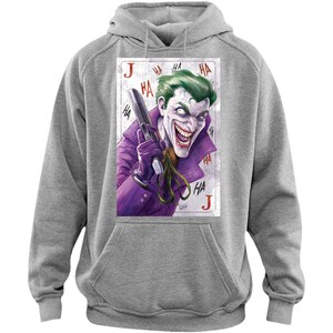 May include: Gray hoodie featuring a graphic of the Joker holding a gun, set against a playing card design. The Joker is depicted with green hair, purple attire, and a sinister grin. The word "HA" is repeated around the image.