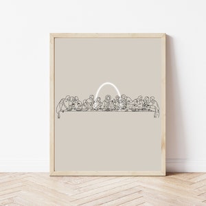 May include: A minimalist line art print of the Last Supper with a white arch above the table. The print is framed in a light wood frame and has a beige background.
