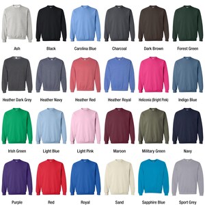a bunch of different colored sweaters on a white background