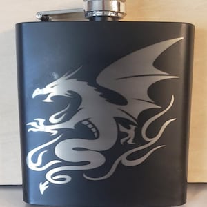 A 6oz. black flask with a dragon engraved on it
