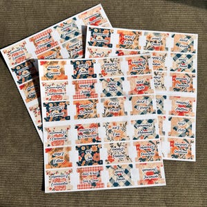 May include: Sheets of Bible verse labels with floral and plaid patterns. Each label features a book of the Bible, such as Genesis, Exodus, and Psalms. The labels are in various colors, including red, blue, and white.