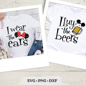 May include: Two white t-shirts with black text and graphics. The first shirt says "I wear the ears" with a red and white Minnie Mouse bow. The second shirt says "I buy the beers" with a cartoon Mickey Mouse holding a beer mug.