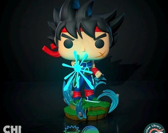May include: A blue and green Pop figure of a character with black hair and a red headband. The figure is holding a blue energy blast in front of them. The figure is standing on a green base with blue energy effects.